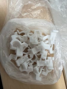 Bag of White Molded Plastic Clips / Saddle Brackets (assorted)